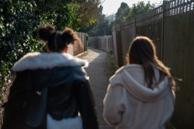 young people walking down a street together