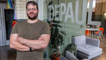 Alex Szoard standing in the Depaul UK offices.