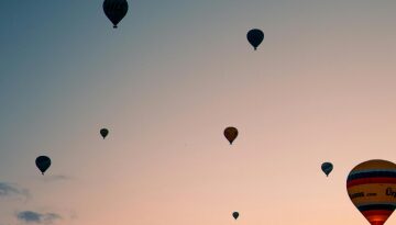 Stock photo of hot air balloons over sunset